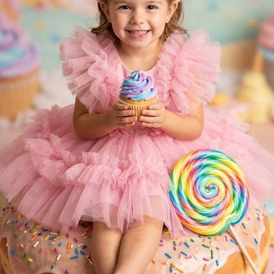 ✏  girl in fluffy pink dress, sitting atop a giant donut wit