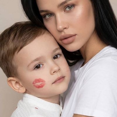 Large portrait of mother and child in studio lighting, vertical composition. Mom
