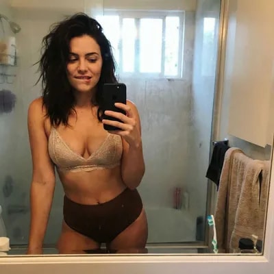 Casual mirror selfie in a bathroom, smartphone pho...