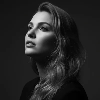 Portrait of a woman with long, wavy hair, looking ...