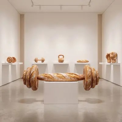 surreal luxury art installation where oversized sports equipment is sc