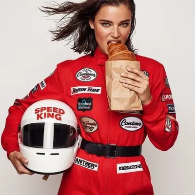 Medium shot, studio photoshoot on a light solid background. The model 